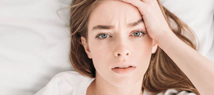 Kisses groom holds arms